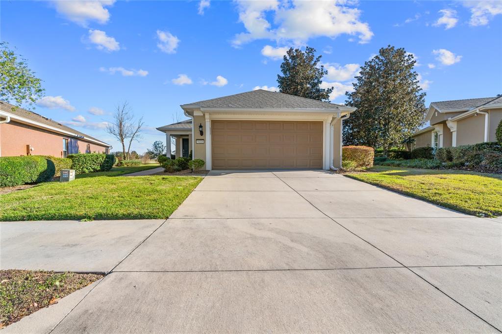 a view of a house with a yard and garage