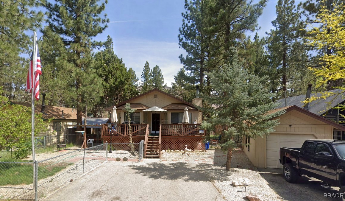 a view of a house with backyard porch and sitting area