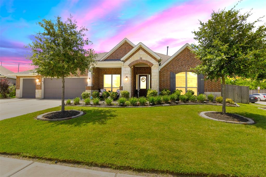 a front view of a house with a yard and garage