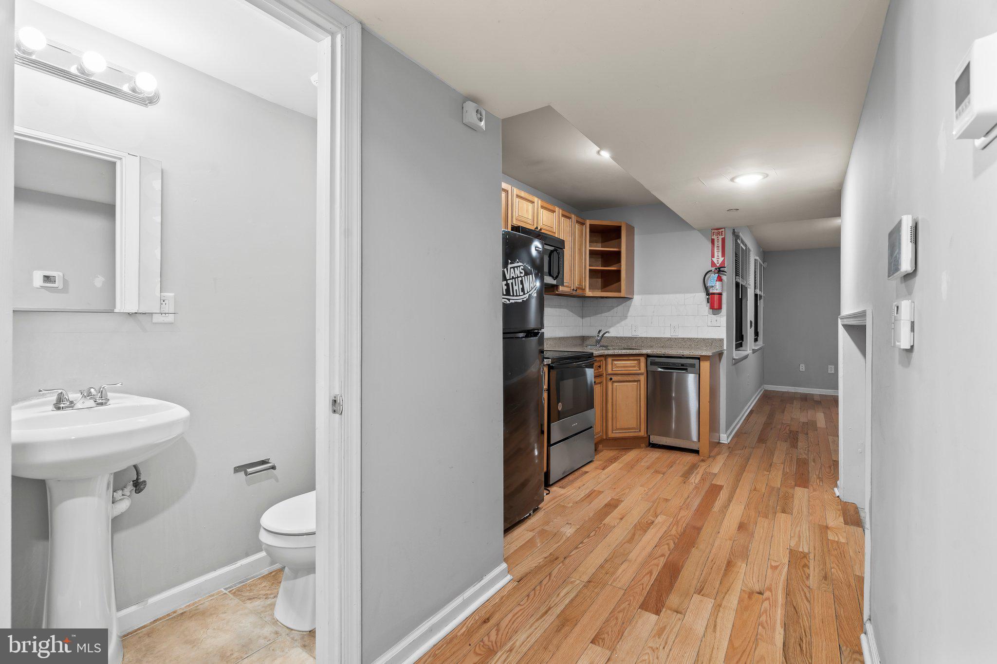 a bathroom with a sink toilet and mirror