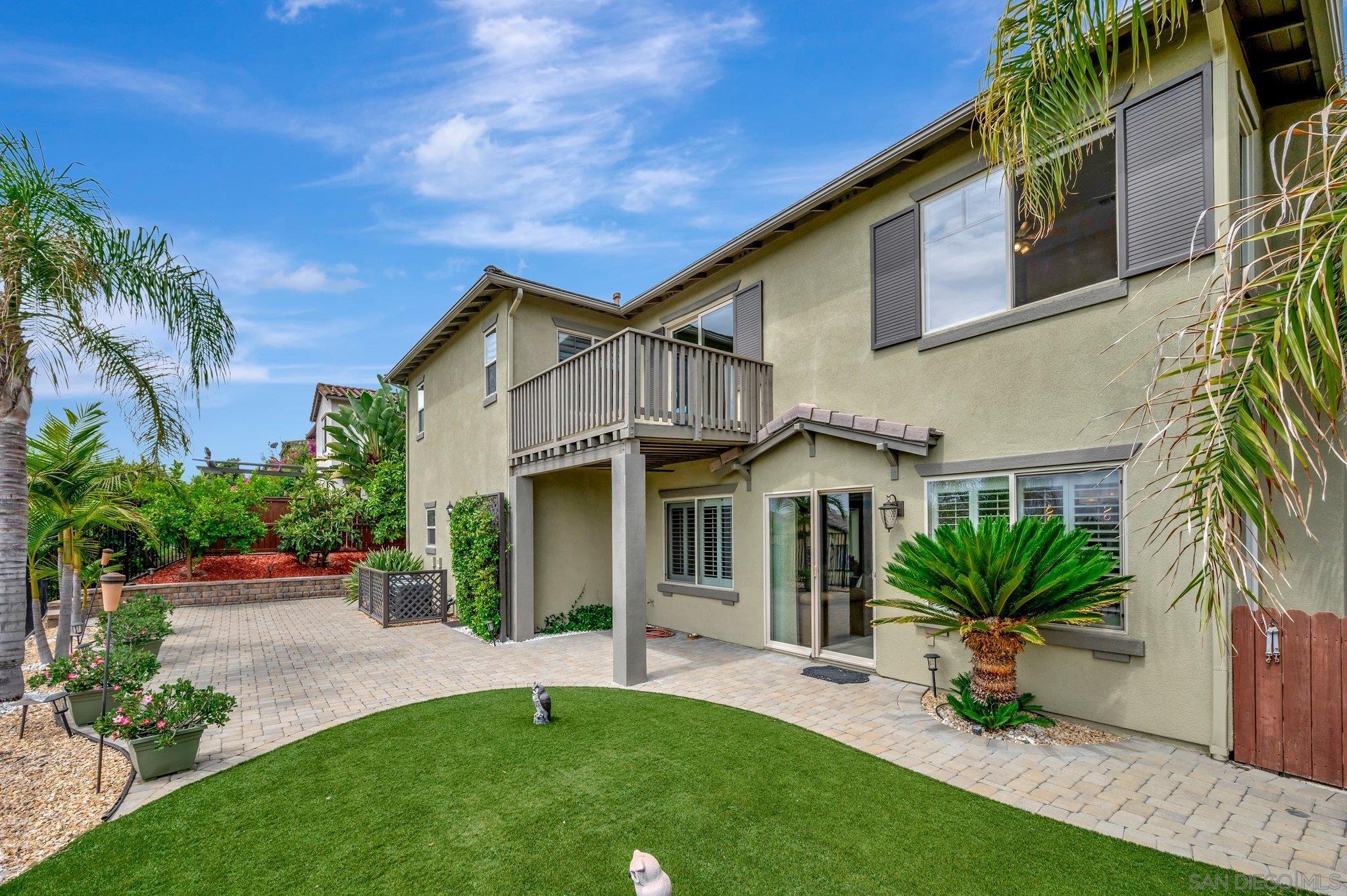 a front view of a house with a yard and potted plants