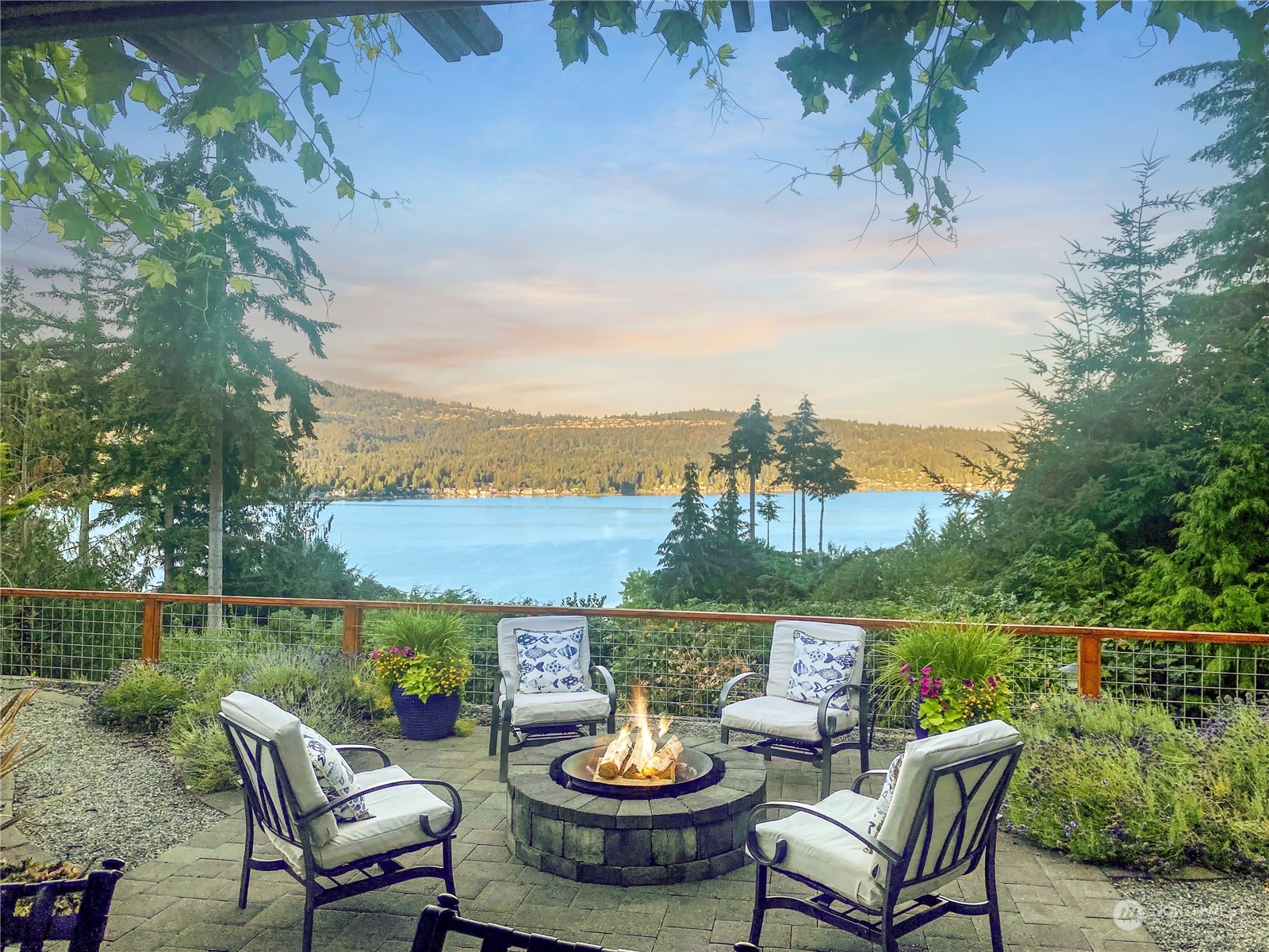 a view of a patio with furniture and a lake view