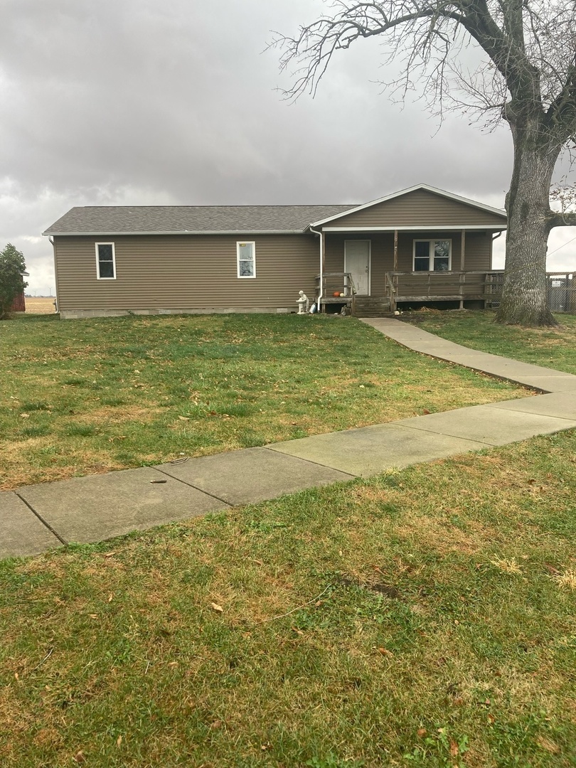 a front view of a house with a big yard