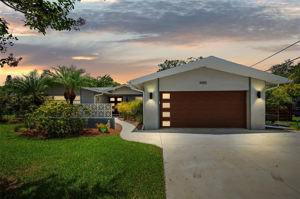 a front view of a house with a yard and garage