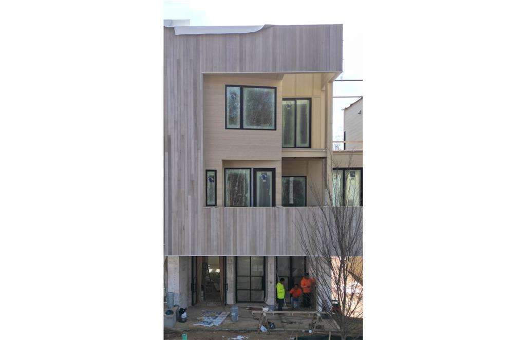 a front view of a house with wooden fence