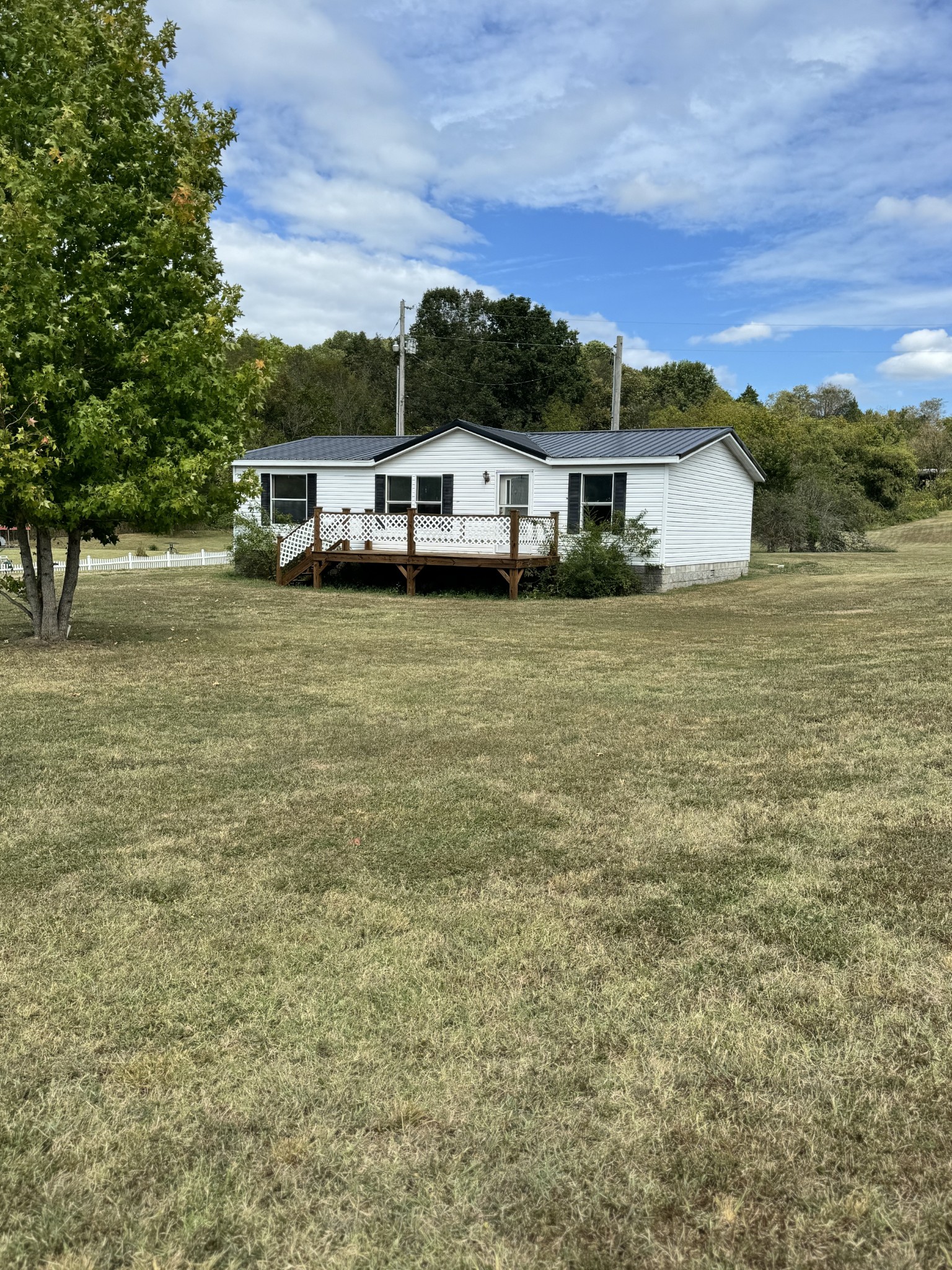 a front view of a house with a yard and trees