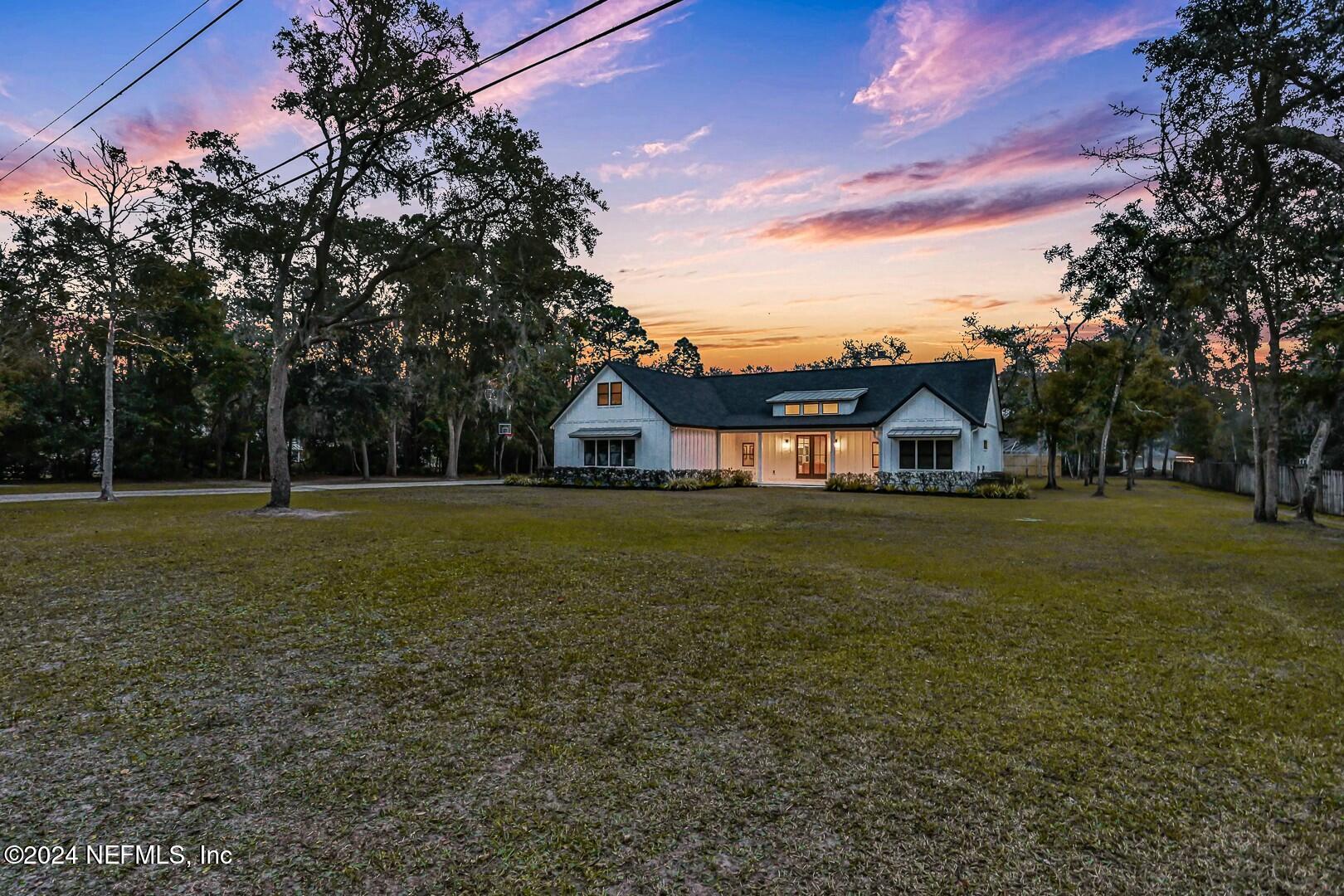 a front view of house with yard and green space