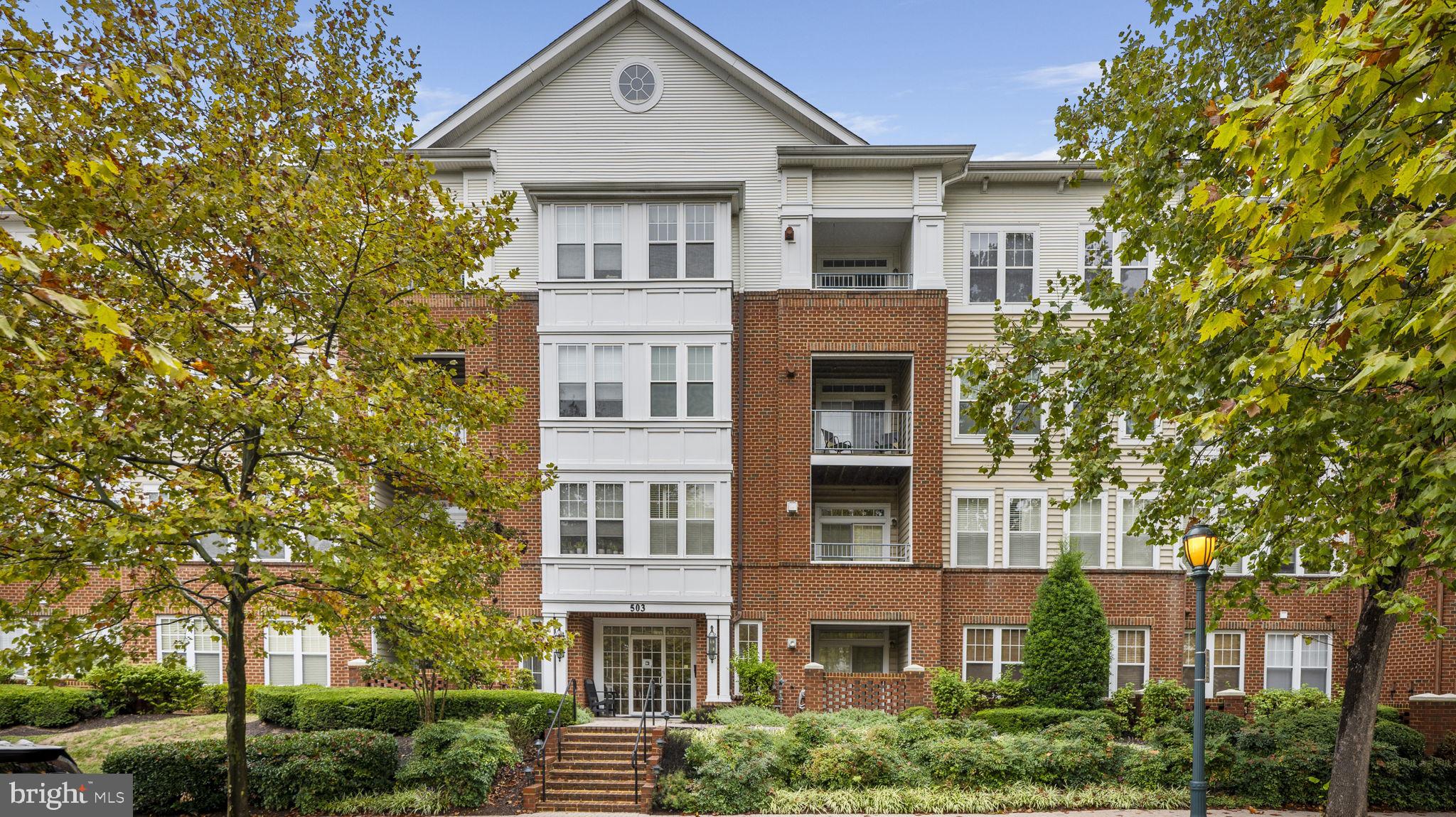 a front view of a residential apartment building with a yard