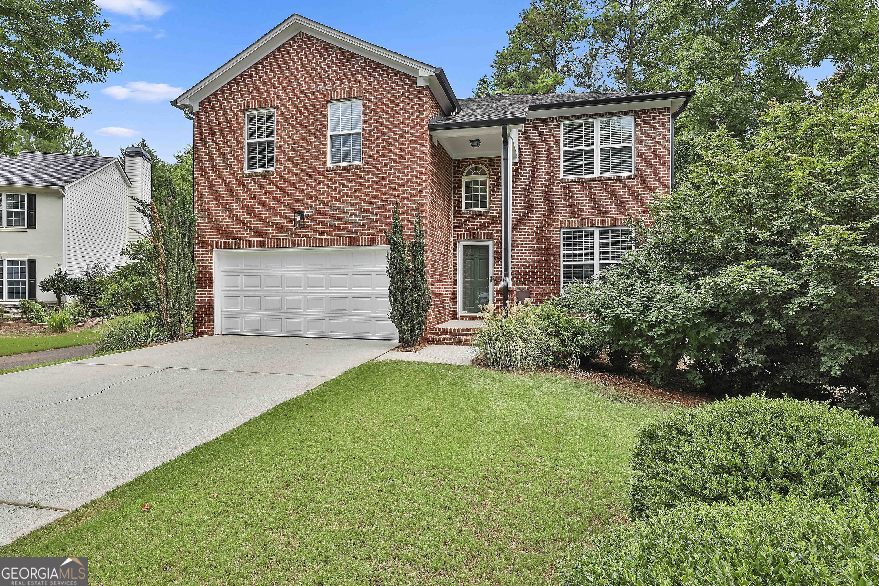 a front view of a house with a yard and garage