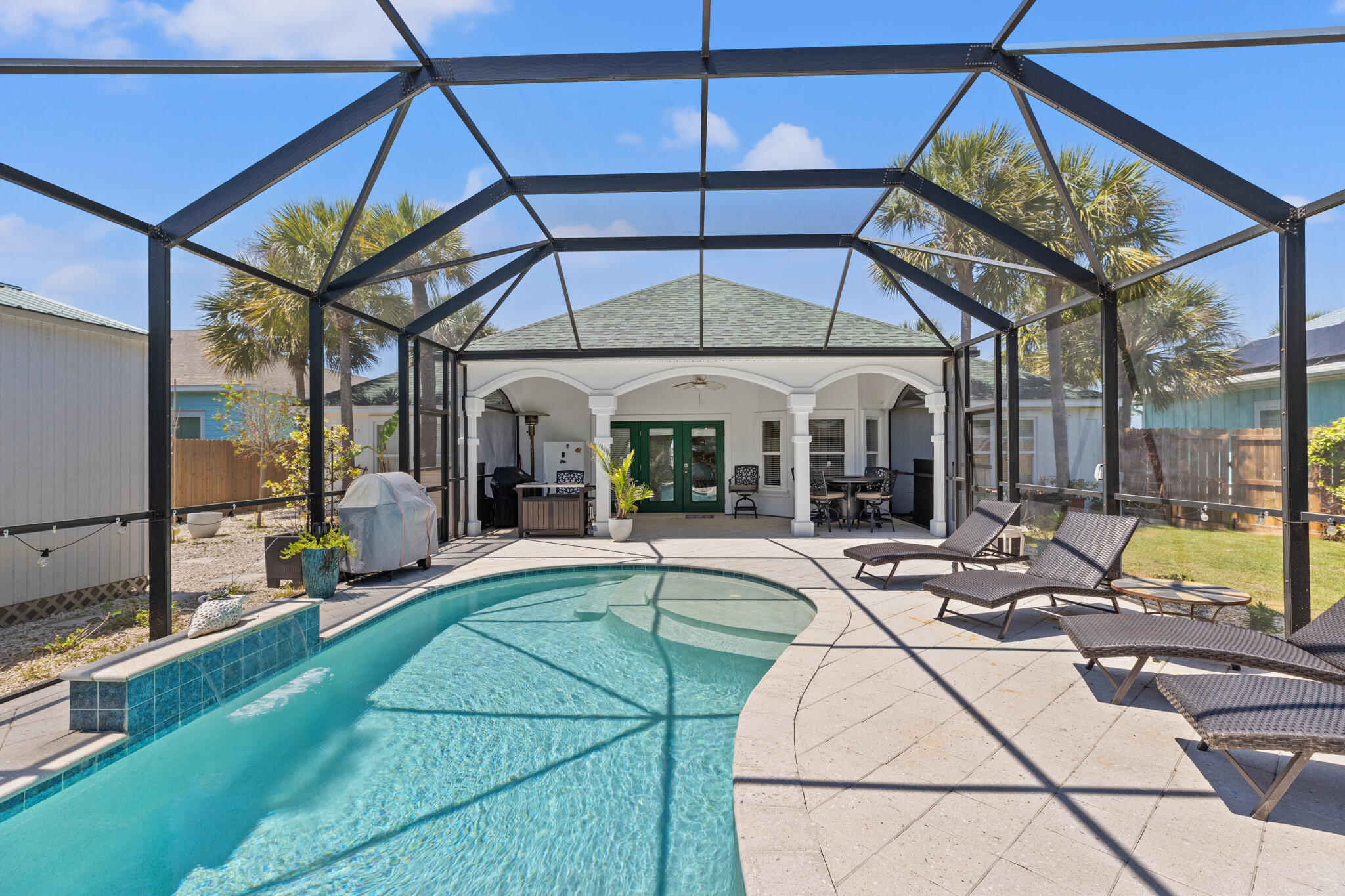 a view of a house with backyard and sitting area