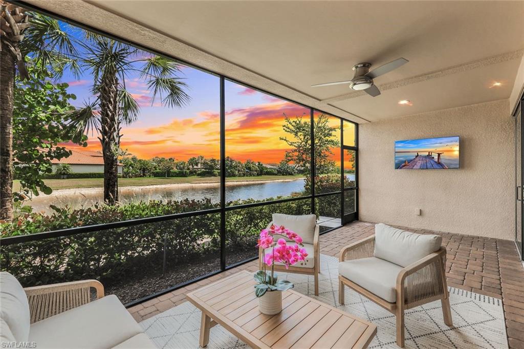 a living room with furniture and a floor to ceiling window