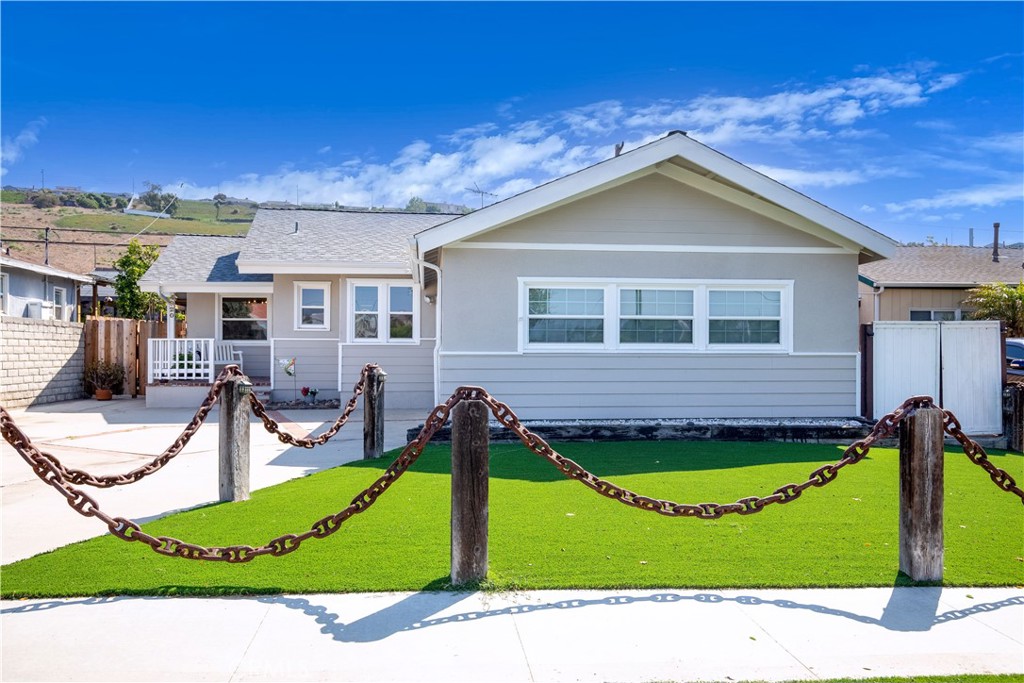 a view of a house with yard and sitting area