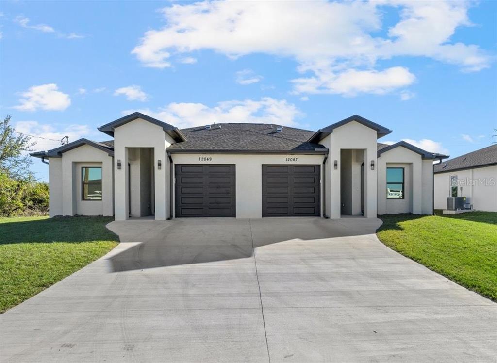 a front view of a house with a yard and garage