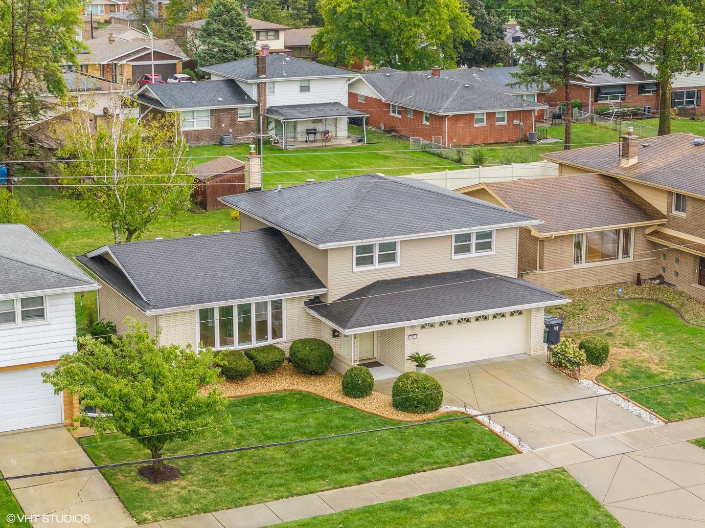 a aerial view of a house with a yard and plants