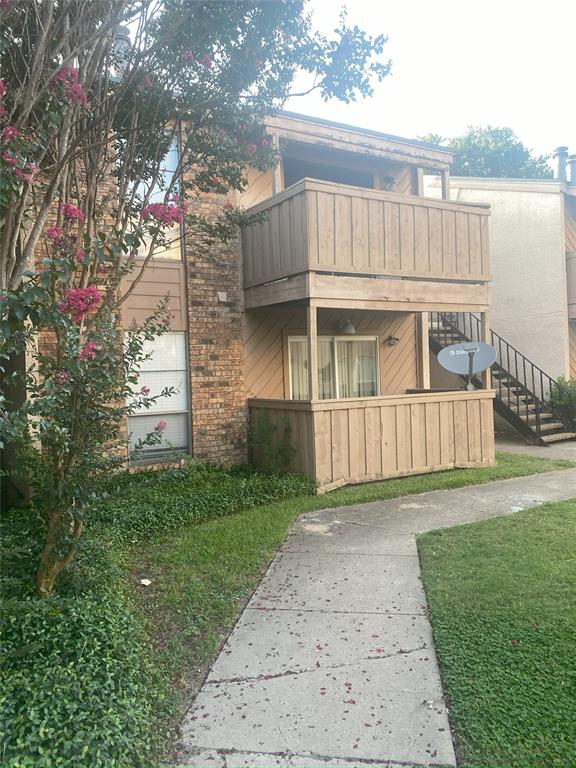 a view of backyard with barbeque grill and wooden fence