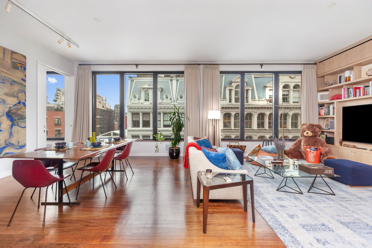 a living room with furniture and floor to ceiling windows