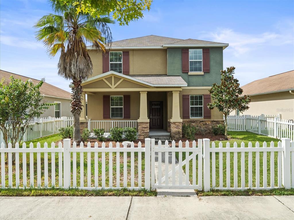 a front view of a house with a garden