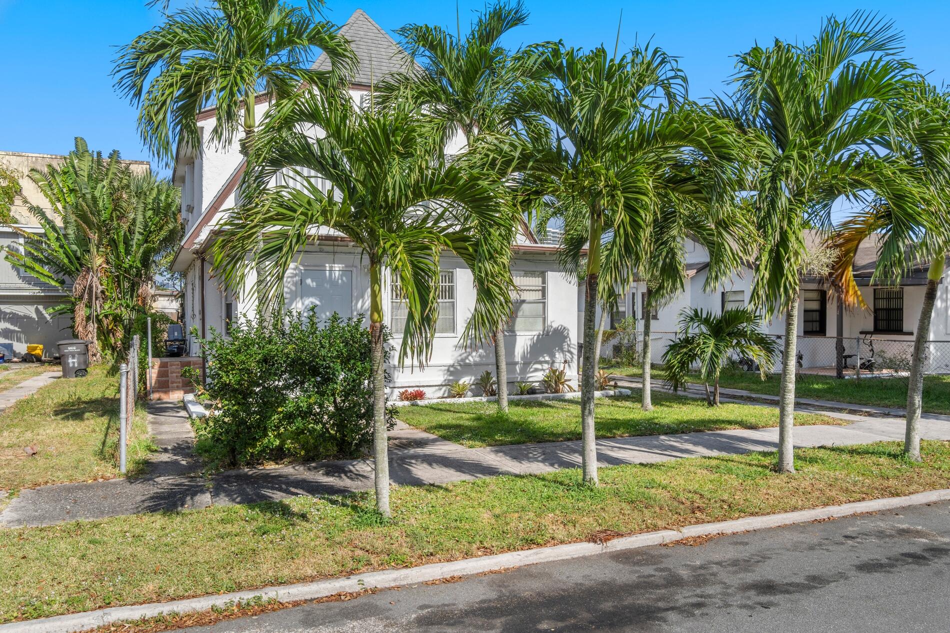 a house with palm tree in front of it