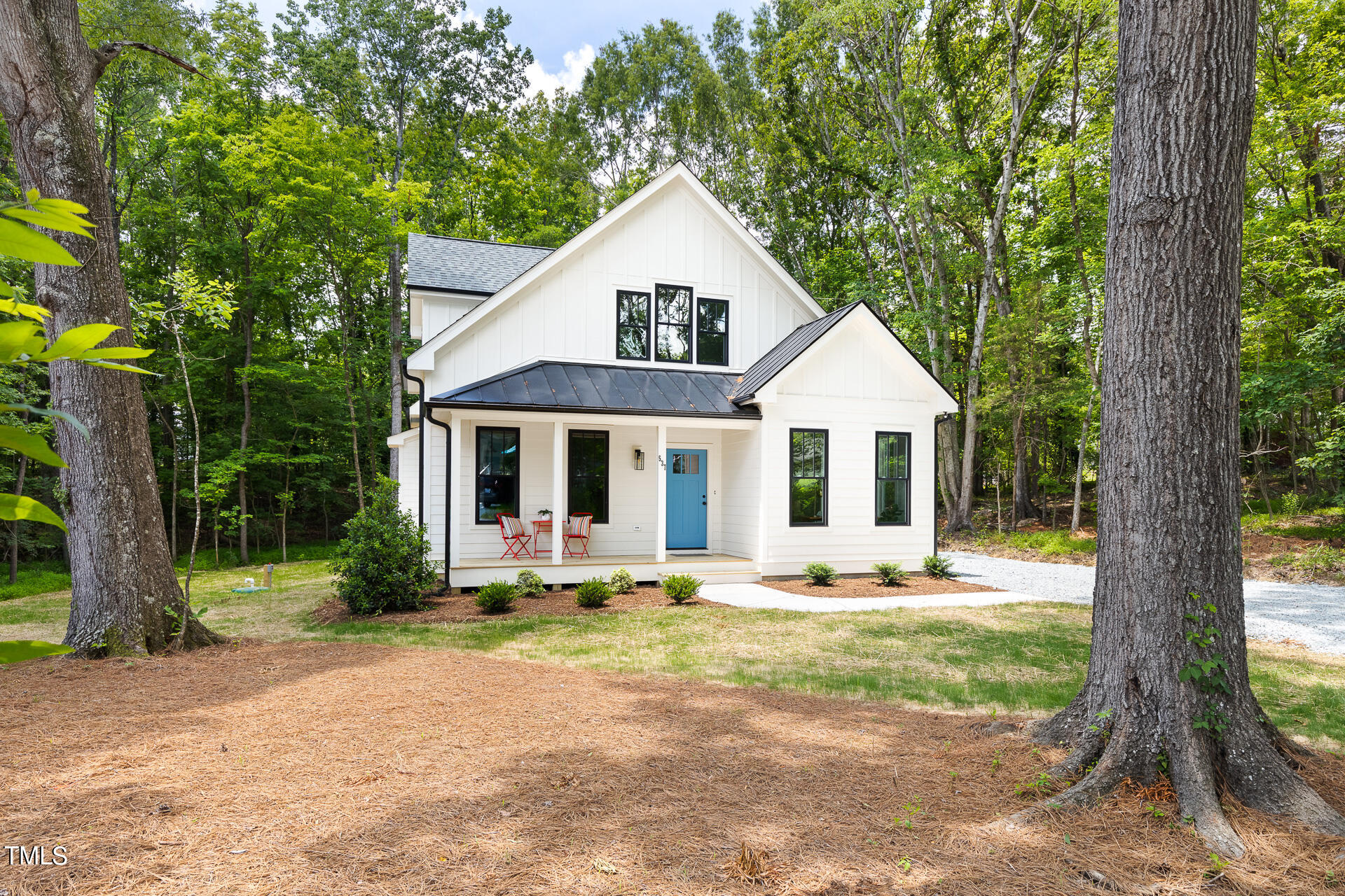 a front view of house with yard outdoor seating and green space