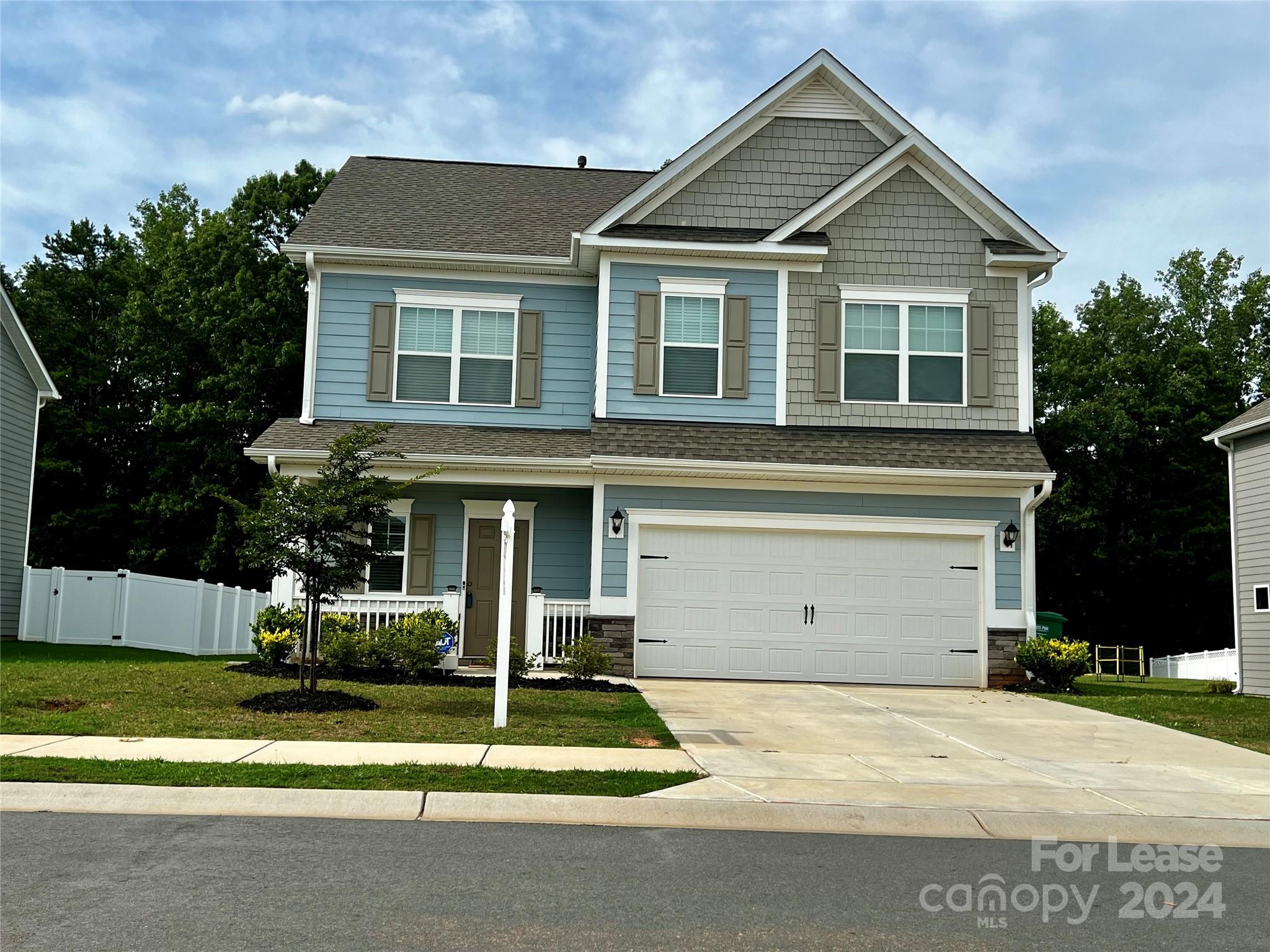 a front view of a house with a yard garage and outdoor seating