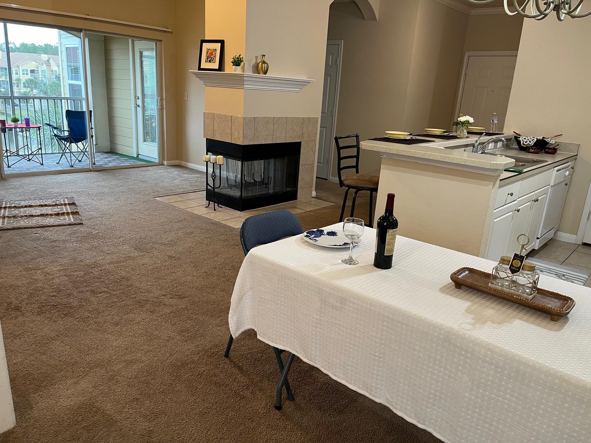 a room with a table chairs and a fireplace