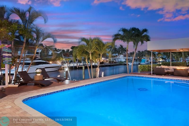 a view of a swimming pool with outdoor seating