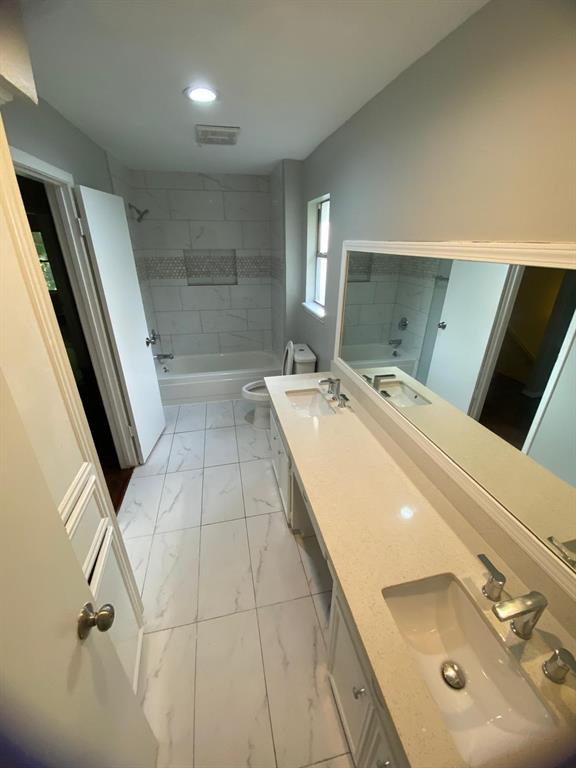 a bathroom with a double vanity sink and mirror