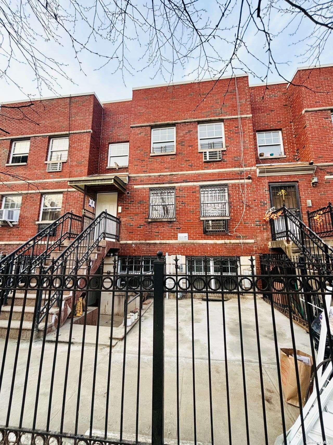 a view of a brick house with large windows