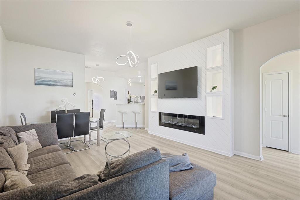 a living room with furniture fireplace and flat screen tv