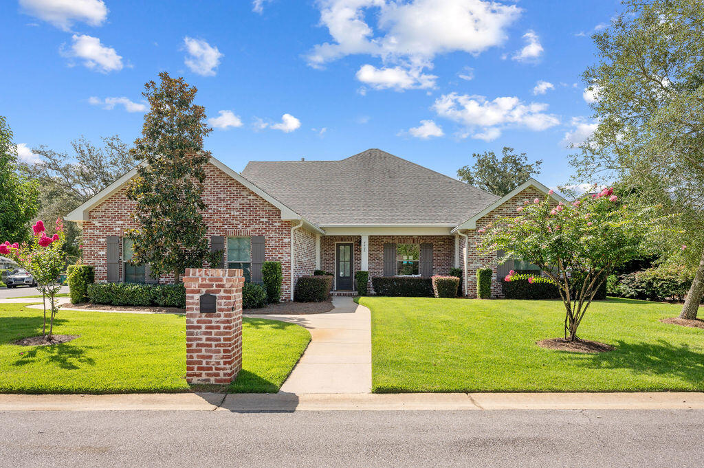 a front view of a house with garden and patio