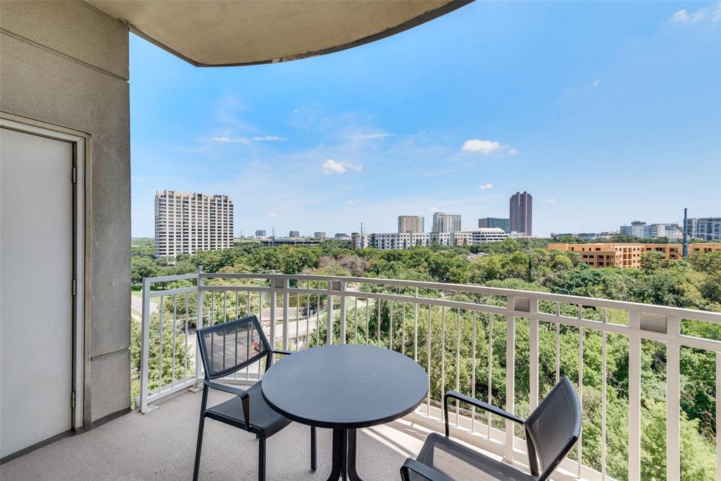 a balcony with table and chairs