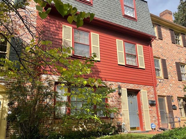 front view of a brick house with a yard