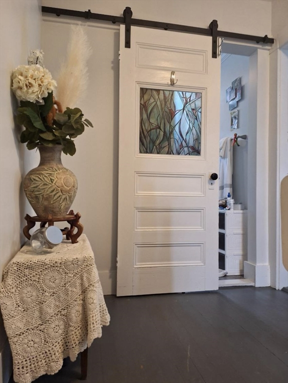 a room with a walk in closet and a mirror