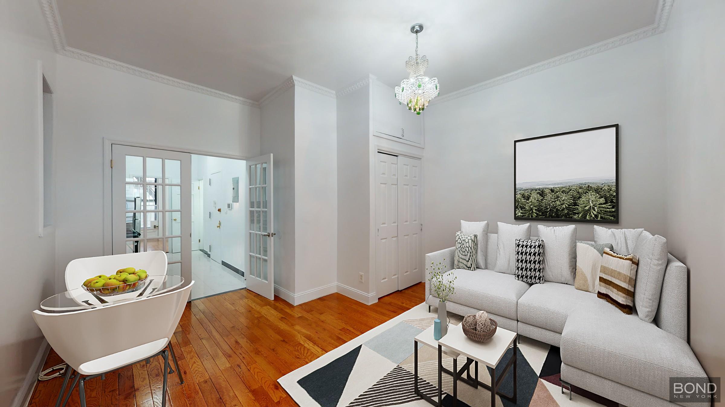 a living room with furniture and a chandelier