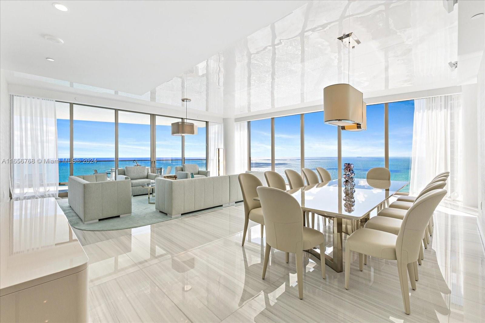 a dining room with furniture and a large window