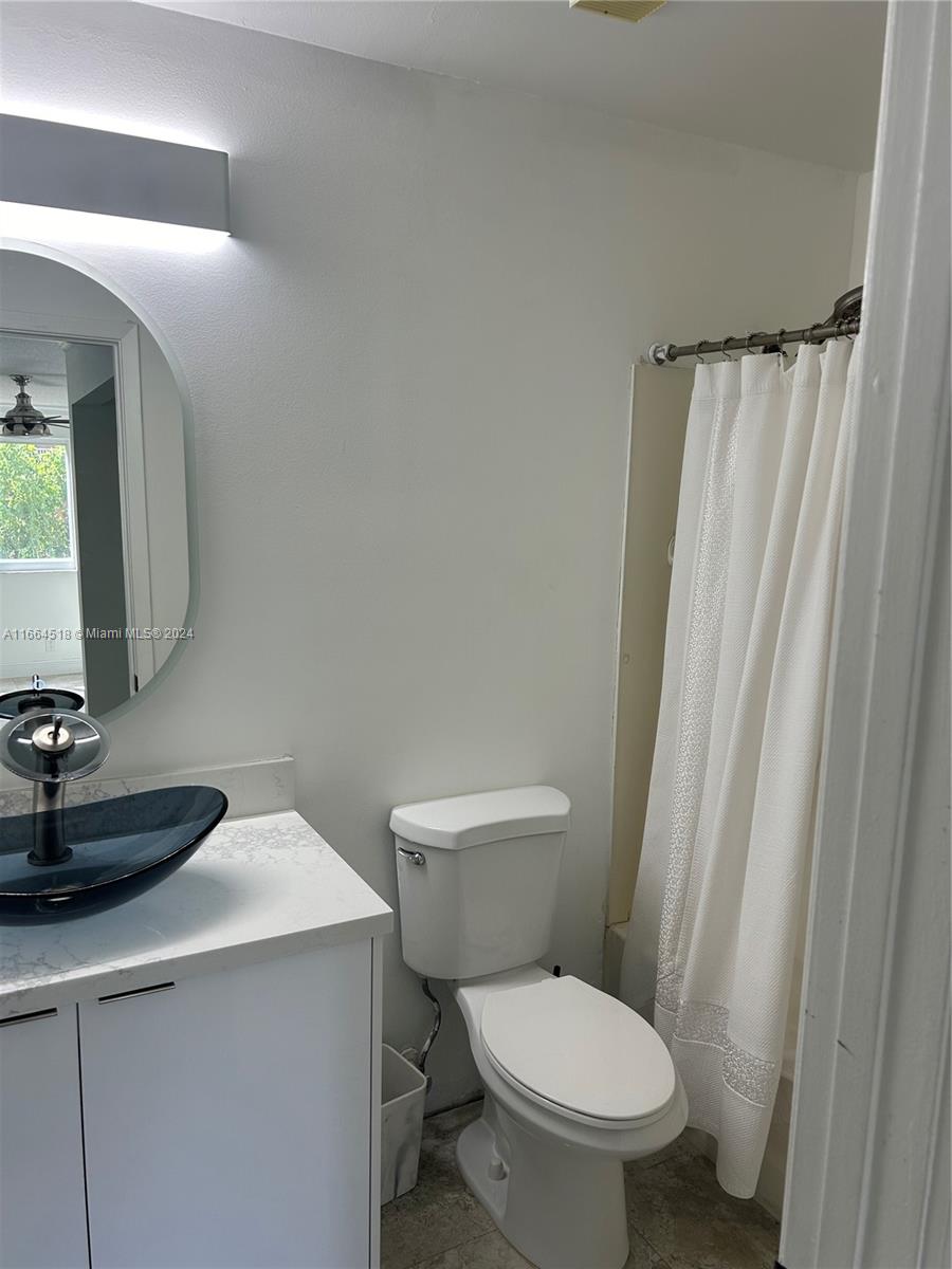 a white toilet sitting next to a bathroom sink