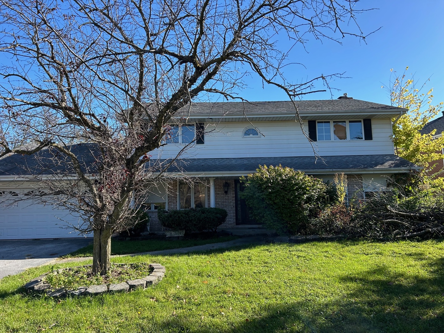 a house that has a tree in front of it