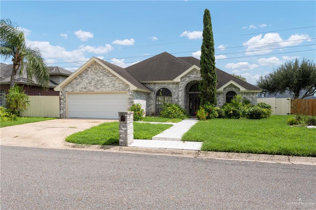 a front view of house with yard and green space