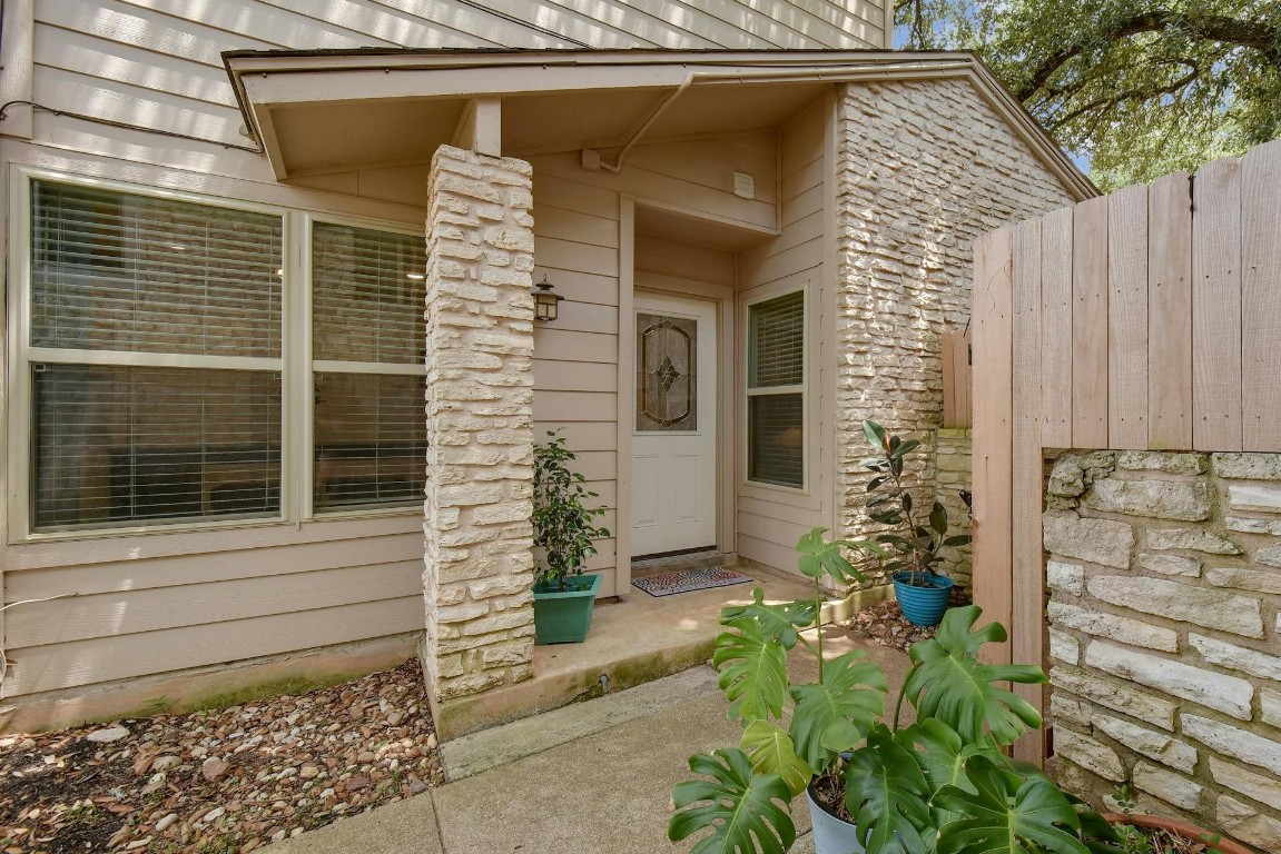 a front view of a house with a yard and seating space