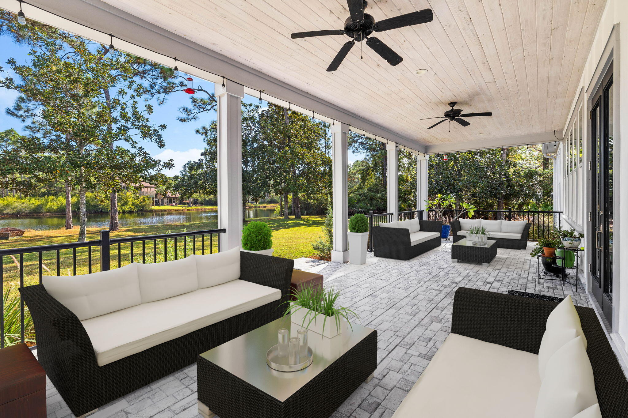 a view of a patio with couches potted plants and pool