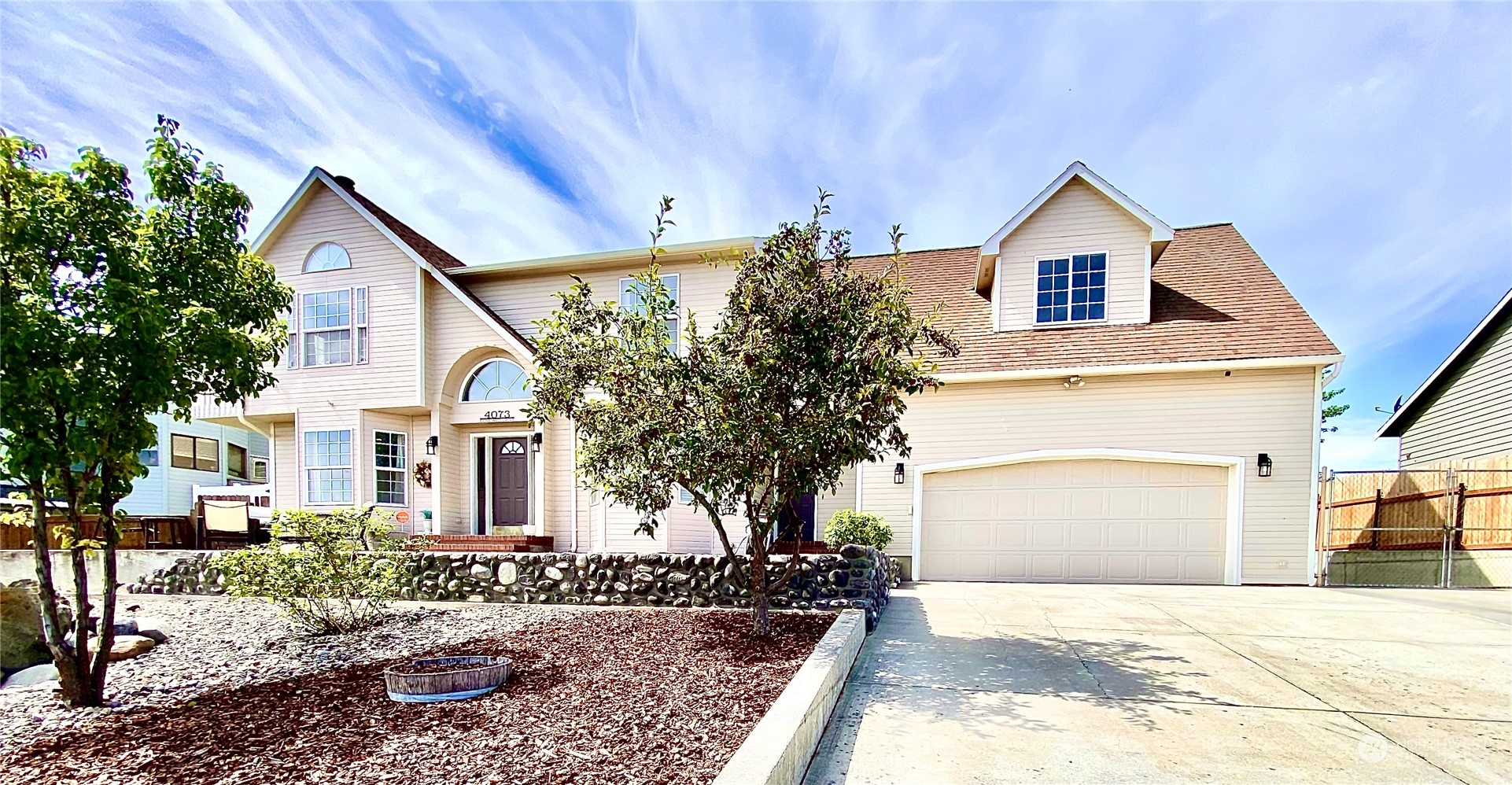 a front view of a house with garden