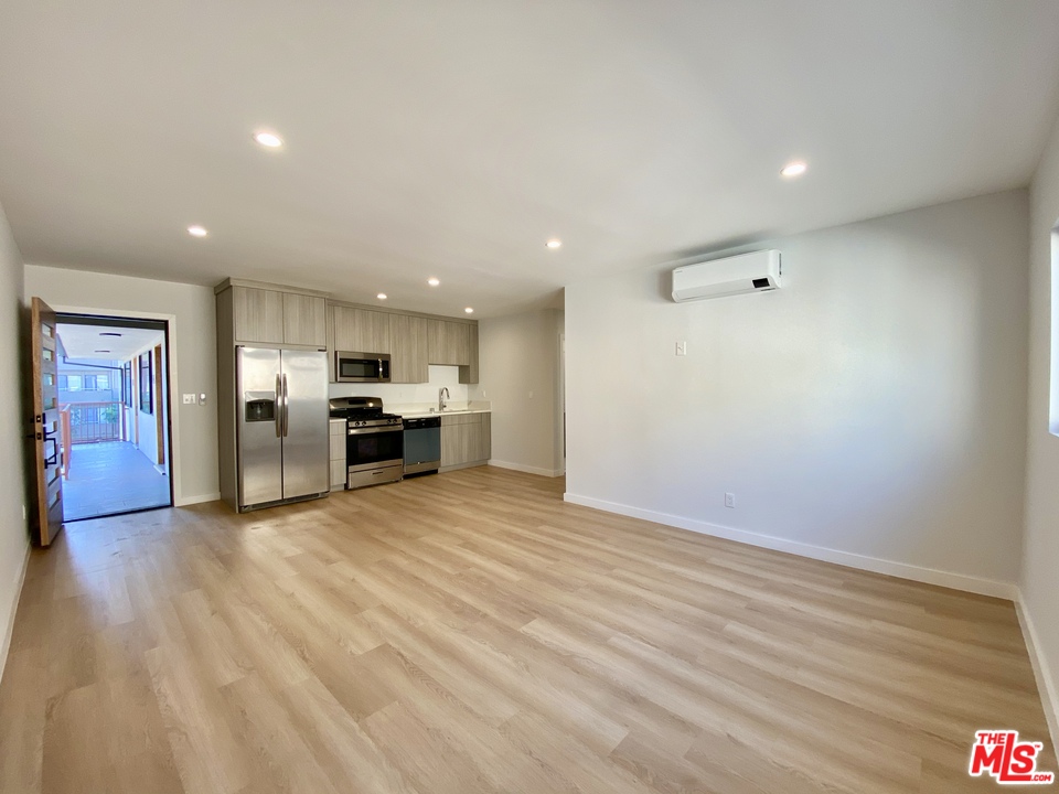 a view of kitchen with refrigerator and window