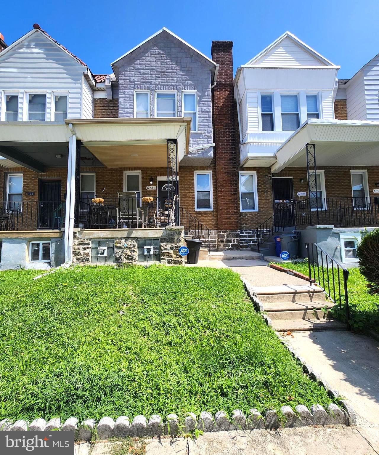 a front view of a residential apartment building with a yard