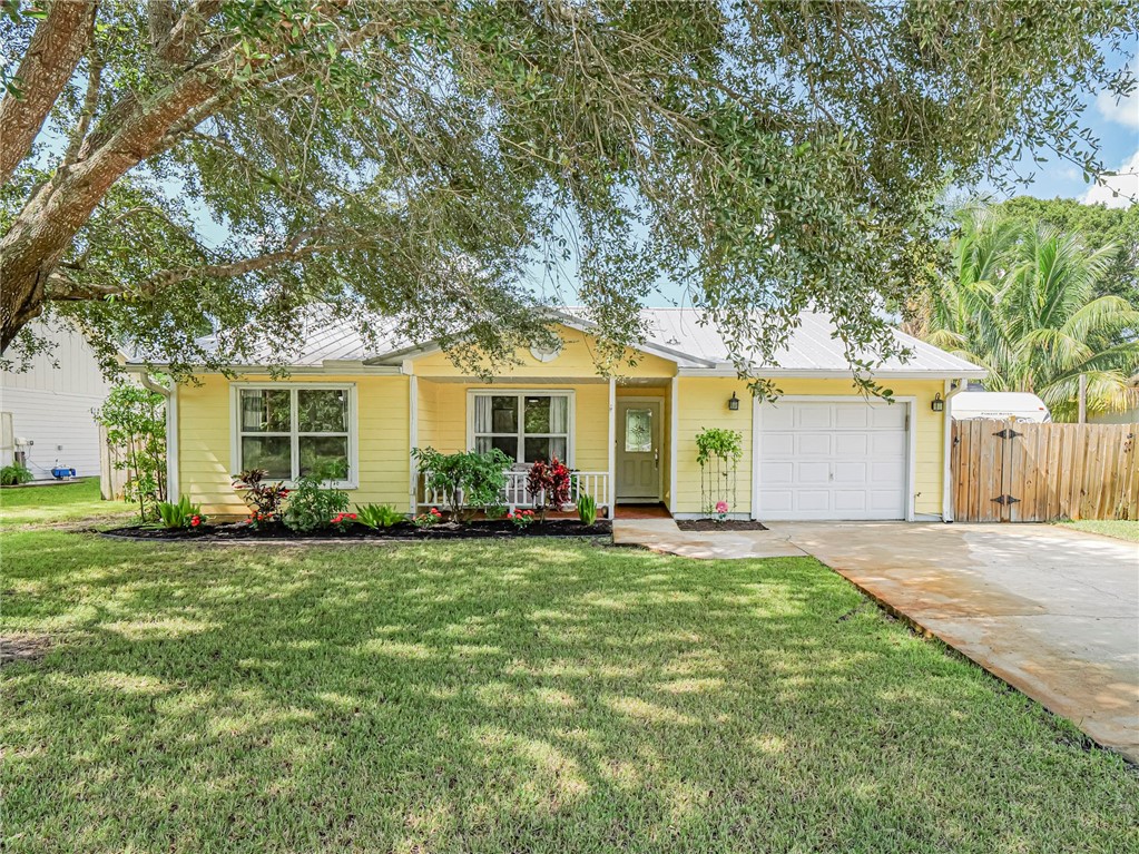 a front view of a house with a yard and trees