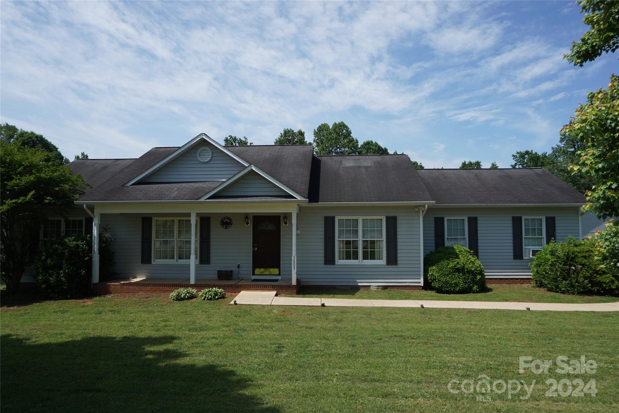 a front view of a house with a garden