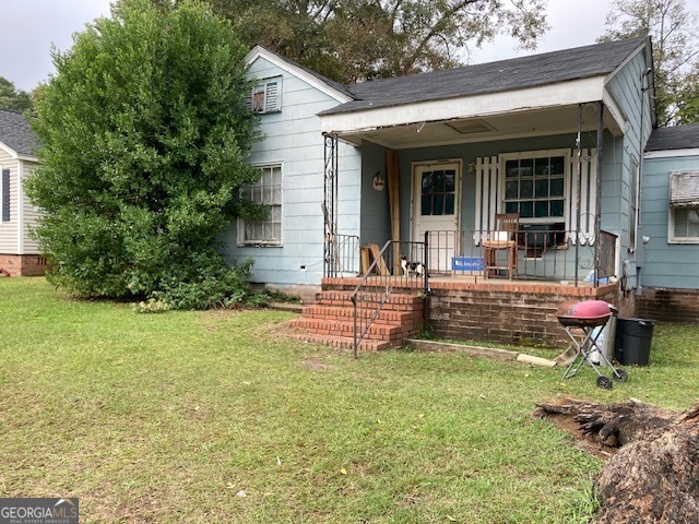 a house view with a sitting space and garden