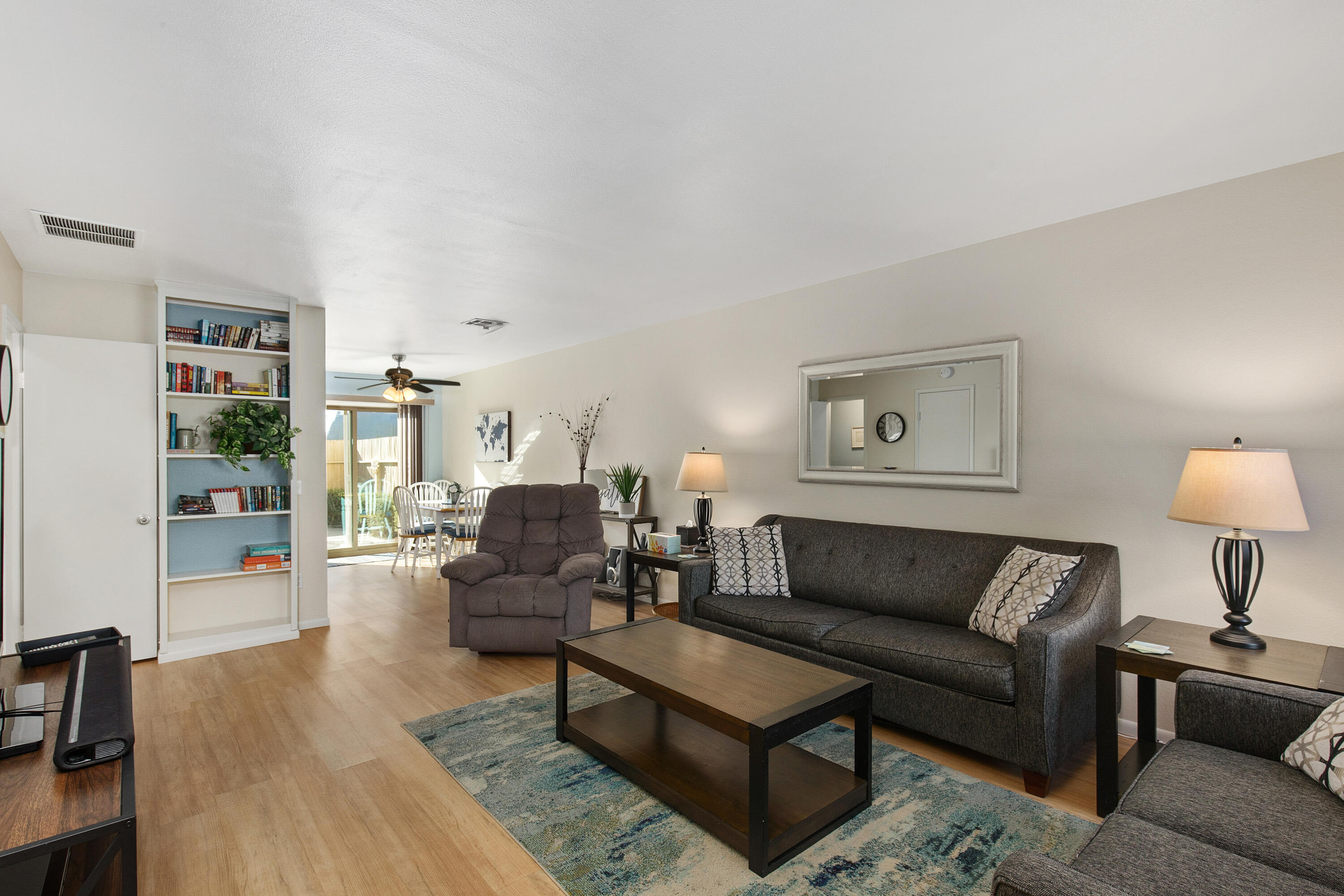 a living room with furniture and a lamp