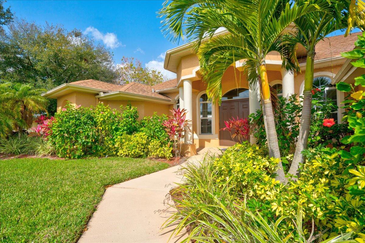 a front view of a house with a yard and fountain