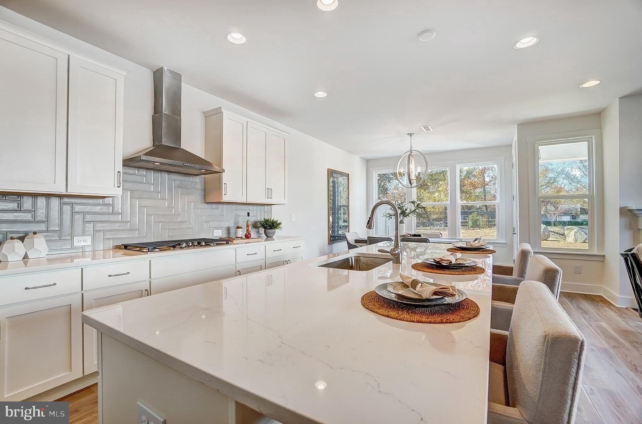 a large kitchen with sink refrigerator and cabinets