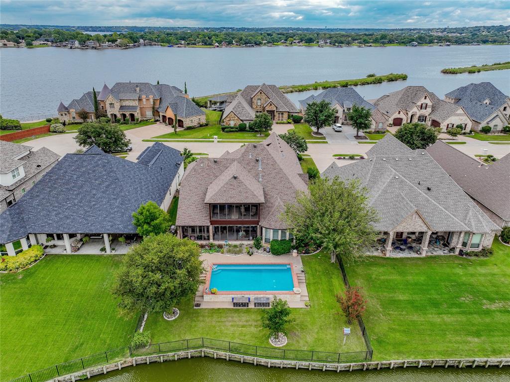 an aerial view of a house with garden space and lake view